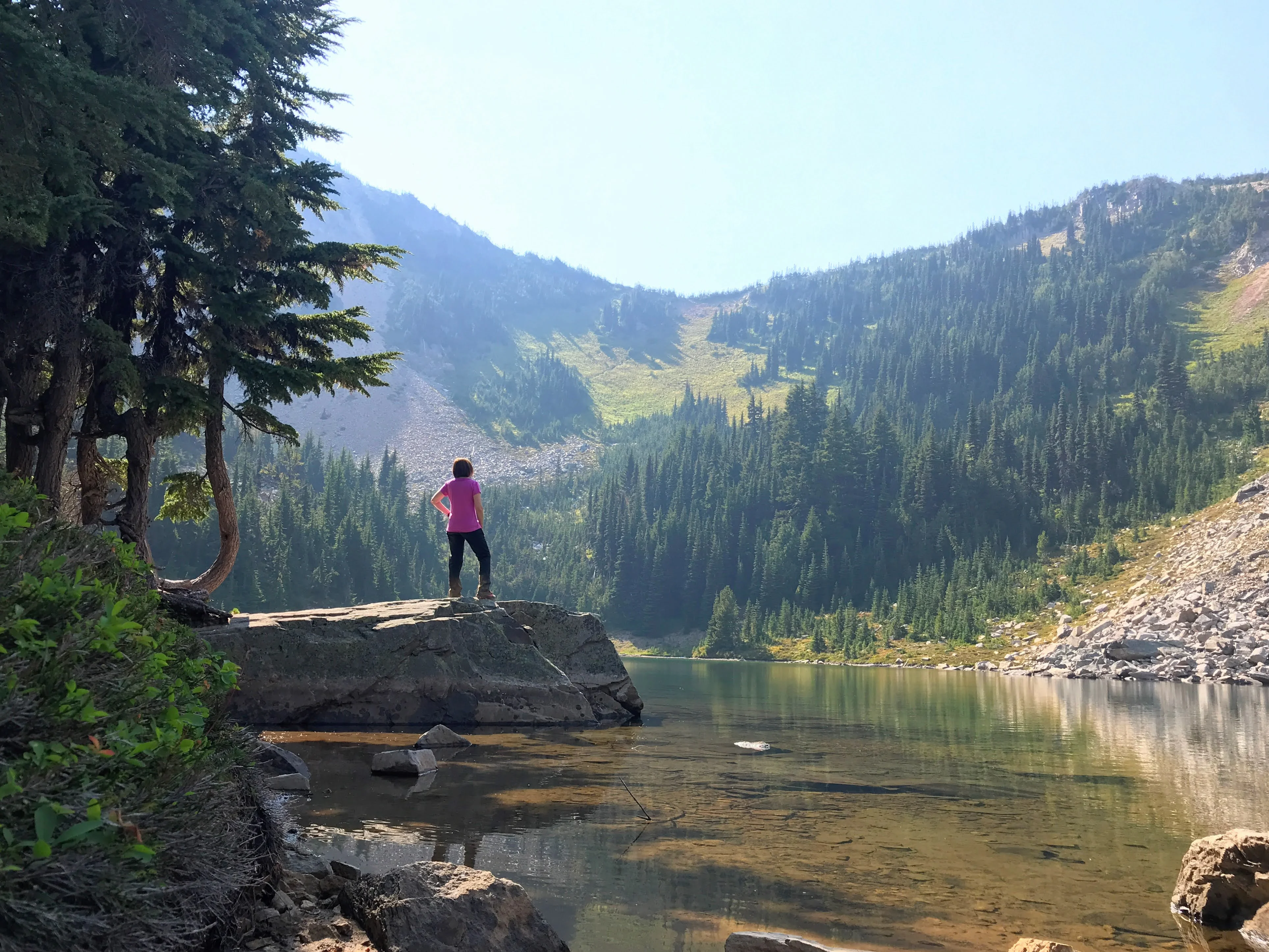 Clear, still water reflects the forest surrounding Hidden Lake.