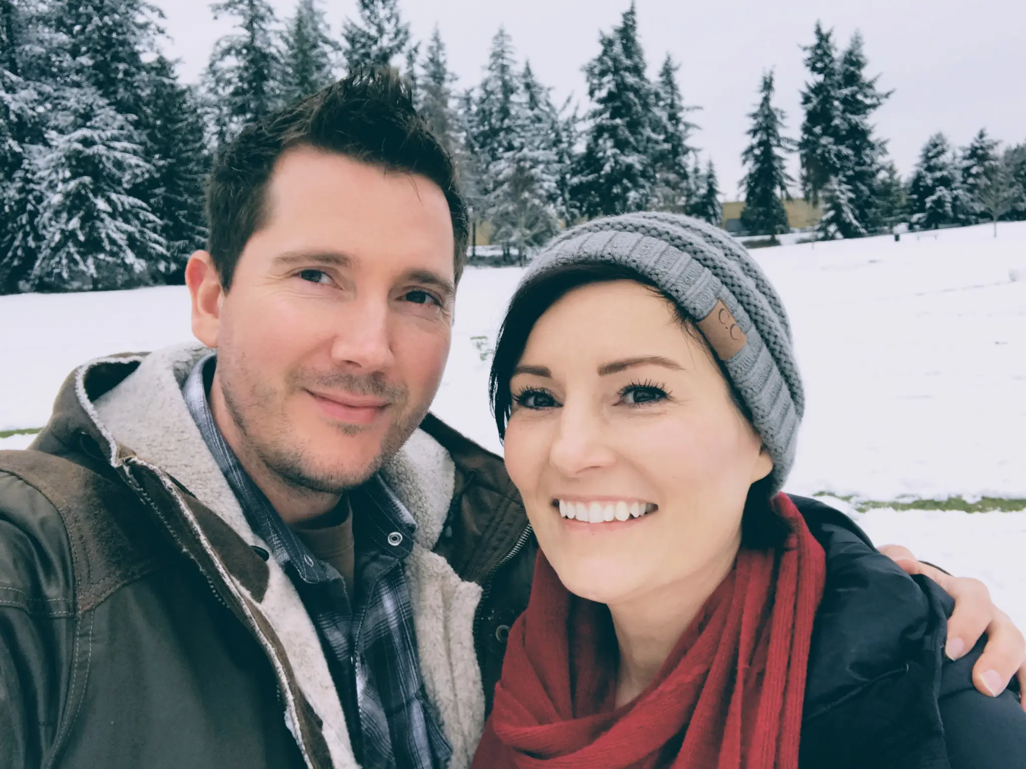 Stacy and Brandon pose together outdoors during a snowy day at Bradley Lake Park.