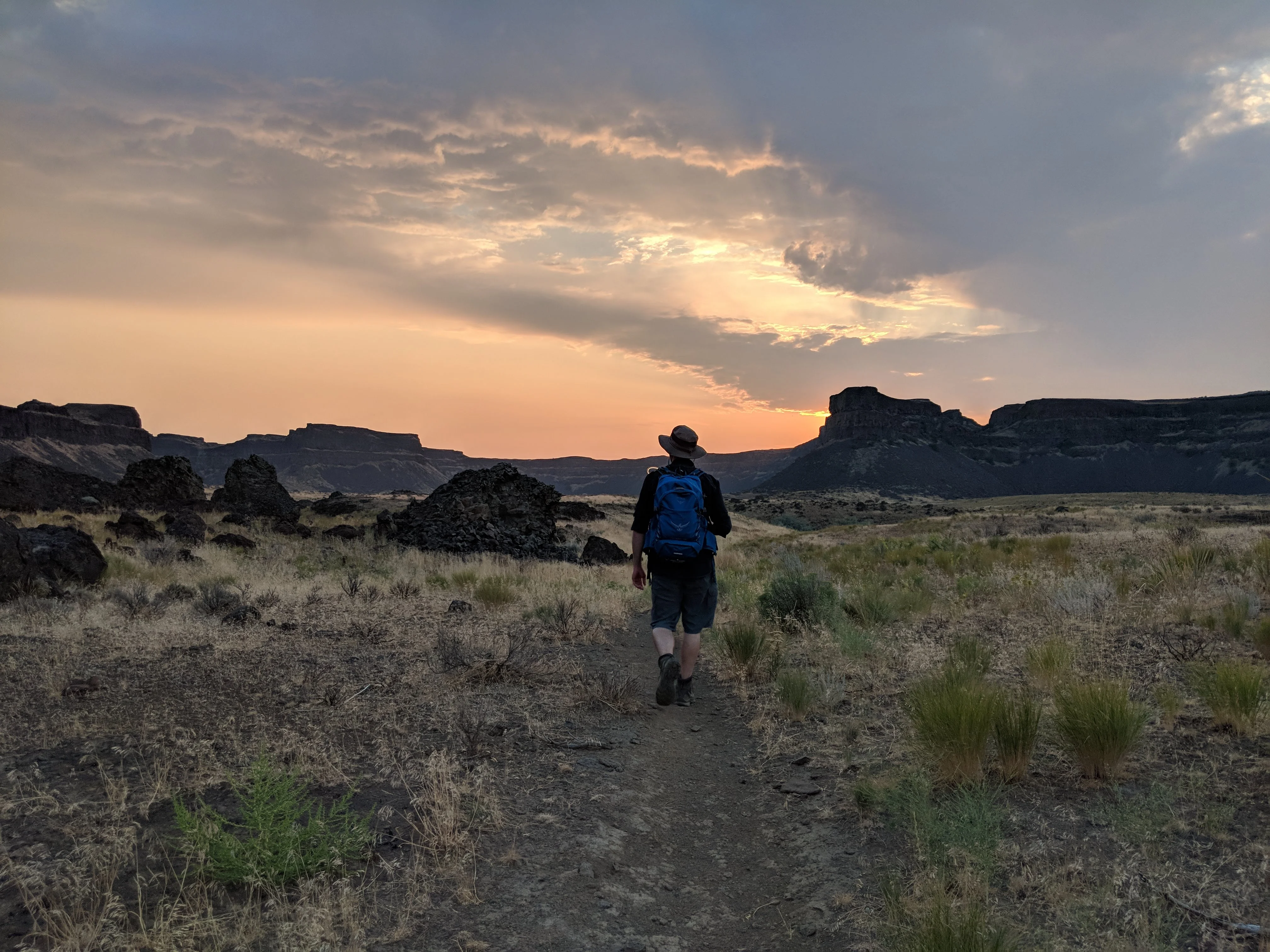 The rising sun casts warm light across the landscape near Umatilla Rock.